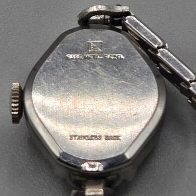 LOT 155J: Vintage Avon Snowflake Rhinestone Earrings, Elgin Starlite Silver Tone 17 Jewels Watch, and Silver-tone Bracelet