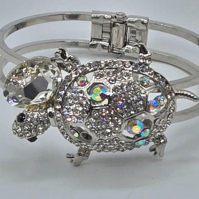 LOT 173J: Silver-tone Jewelry Including Rhinestone Turtle Clamper Bracelet, Bib Necklace, Multiple Bangle and Cuff Bracelets, and More