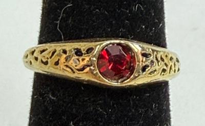 Sale Photo Thumbnail #11: Round red stone (imitation ruby?), ring has no markings. Size 5. Very Pretty.