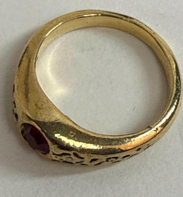 Sale Photo Thumbnail #12: Round red stone (imitation ruby?), ring has no markings. Size 5. Very Pretty.