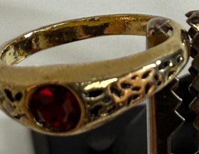 Sale Photo Thumbnail #13: Round red stone (imitation ruby?), ring has no markings. Size 5. Very Pretty.