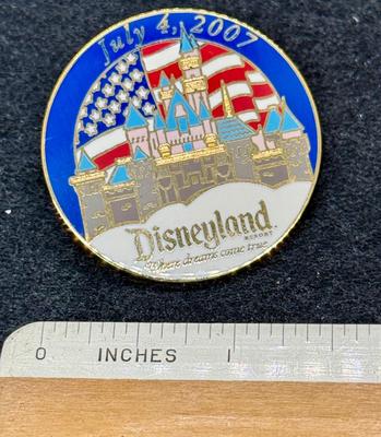 Sale Photo Thumbnail #430: Round pin with the Sleeping beauty Castle and an American flag. Great condition.