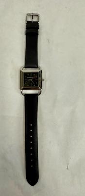 Sale Photo Thumbnail #380: Square black watch face, bright silver rim. Black Leather strap. Hands can be adjusted, but watch isn't running, most likely needs a new battery.  Looks to be new and unworn.