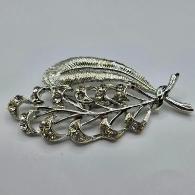 LOT 411: Multiple Pairs of Clip Earrings, Brooches, Silver-tone Chain with Winter Charms, and More