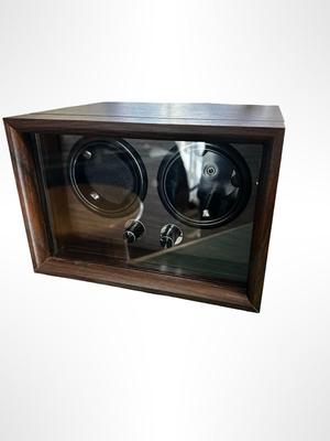 Sale Photo Thumbnail #580: Dual Watch Winder housed in a dark wood case with a glass display.