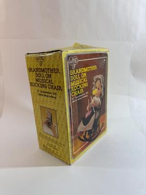 Sale Photo Thumbnail #252: In original box. Wind-up music plays. One of the chair's arms was broken and repaired, now it is un-attached but can be repaired again.