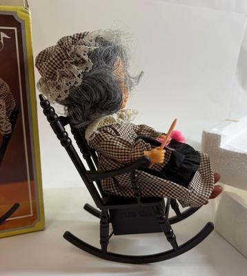 Sale Photo Thumbnail #256: In original box. Wind-up music plays. One of the chair's arms was broken and repaired, now it is un-attached but can be repaired again.