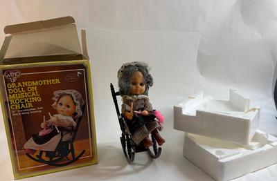 Sale Photo Thumbnail #254: In original box. Wind-up music plays. One of the chair's arms was broken and repaired, now it is un-attached but can be repaired again.