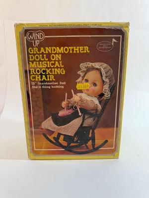 Sale Photo Thumbnail #251: In original box. Wind-up music plays. One of the chair's arms was broken and repaired, now it is un-attached but can be repaired again.