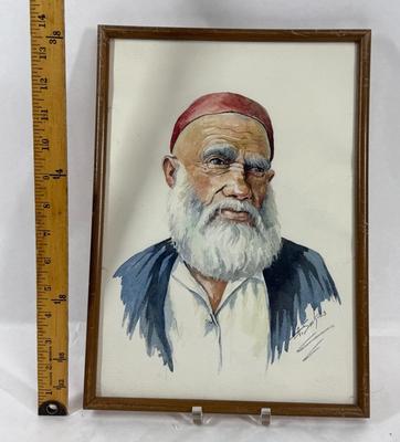 Sale Photo Thumbnail #399: Original watercolor portrait of an elderly man wearing a red fez and traditional attire Middle Eastern attire.  Signed by the artist A. Soo Kiels. Style is similar to Iranian or Turkish portraits.  Good condition, approx. 14" x 10".