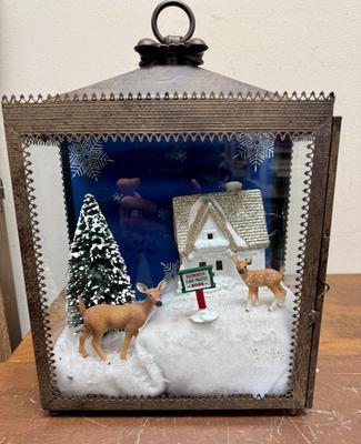 Sale Photo Thumbnail #364: This is a Christmas-themed lantern diorama featuring a "Reindeer Flight Practice Zone" scene. 
In good condition. Deer, sign, and tree are loose and can be rearranged.