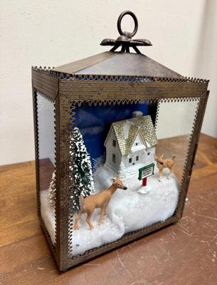 Sale Photo Thumbnail #362: This is a Christmas-themed lantern diorama featuring a "Reindeer Flight Practice Zone" scene. 
In good condition. Deer, sign, and tree are loose and can be rearranged.