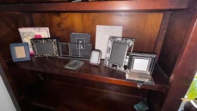 A VARIETY OF PICTURE FRAMES AND PHOTO ALBUMS