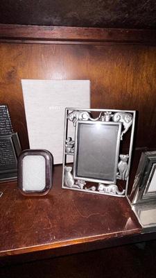 A VARIETY OF PICTURE FRAMES AND PHOTO ALBUMS