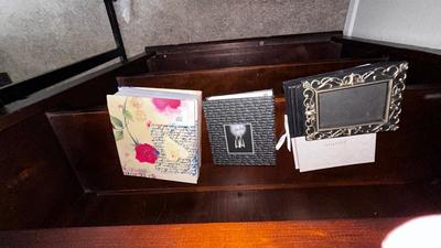 A VARIETY OF PICTURE FRAMES AND PHOTO ALBUMS