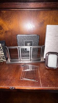 A VARIETY OF PICTURE FRAMES AND PHOTO ALBUMS