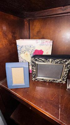 A VARIETY OF PICTURE FRAMES AND PHOTO ALBUMS