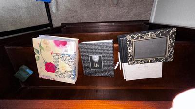 A VARIETY OF PICTURE FRAMES AND PHOTO ALBUMS
