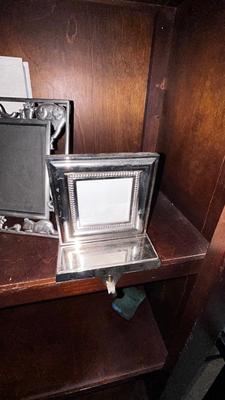 A VARIETY OF PICTURE FRAMES AND PHOTO ALBUMS