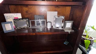 A VARIETY OF PICTURE FRAMES AND PHOTO ALBUMS