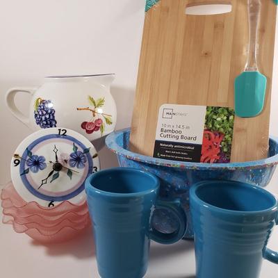 LOT 96: Kitchen Assortment-Pottery Wall Clock, Fiesta Mugs, New Cutting Board & More