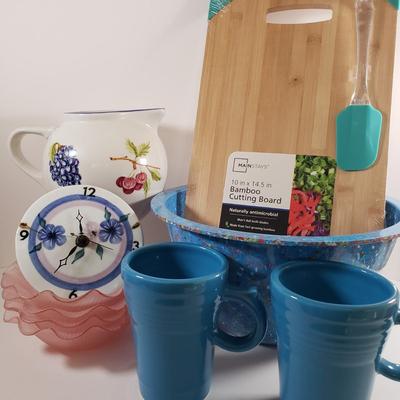 LOT 96: Kitchen Assortment-Pottery Wall Clock, Fiesta Mugs, New Cutting Board & More
