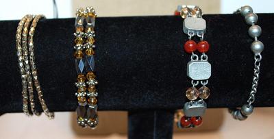 Collection of 4 Assorted BRACELETS (2" Opening) including Marked "AVON"; Amber & Black Beads; & Gray Globes