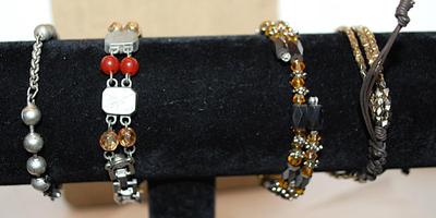 Collection of 4 Assorted BRACELETS (2" Opening) including Marked "AVON"; Amber & Black Beads; & Gray Globes