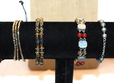 Collection of 4 Assorted BRACELETS (2" Opening) including Marked "AVON"; Amber & Black Beads; & Gray Globes