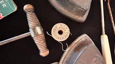 ANTIQUE SAD IRONS, THREAD SPOOLS, GUNNY SACK NEEDLES AND MORE