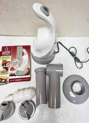 Sale Photo Thumbnail #222: a specific kitchen appliance from Magic Bullet designed to quickly turn frozen fruits (like bananas, berries) and flavors into creamy, healthy soft-serve desserts, resembling ice cream or sorbet, often in under 10 seconds, using a blender-like action with