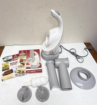 Sale Photo Thumbnail #219: a specific kitchen appliance from Magic Bullet designed to quickly turn frozen fruits (like bananas, berries) and flavors into creamy, healthy soft-serve desserts, resembling ice cream or sorbet, often in under 10 seconds, using a blender-like action with