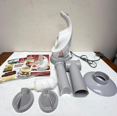 Sale Photo Thumbnail #220: a specific kitchen appliance from Magic Bullet designed to quickly turn frozen fruits (like bananas, berries) and flavors into creamy, healthy soft-serve desserts, resembling ice cream or sorbet, often in under 10 seconds, using a blender-like action with