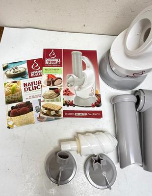 Sale Photo Thumbnail #221: a specific kitchen appliance from Magic Bullet designed to quickly turn frozen fruits (like bananas, berries) and flavors into creamy, healthy soft-serve desserts, resembling ice cream or sorbet, often in under 10 seconds, using a blender-like action with