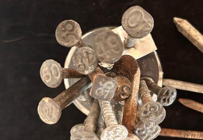 ANTIQUE RAILROAD DATE NAILS AND A GLASS MARBLE REFLECTOR