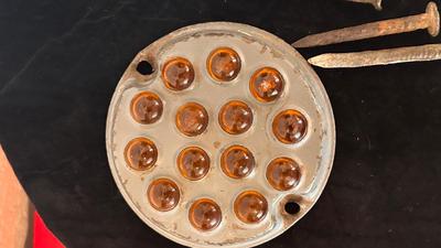 ANTIQUE RAILROAD DATE NAILS AND A GLASS MARBLE REFLECTOR