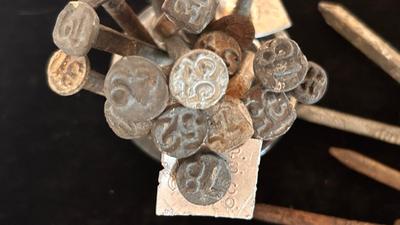 ANTIQUE RAILROAD DATE NAILS AND A GLASS MARBLE REFLECTOR