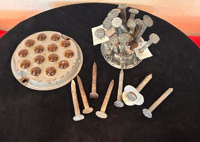 ANTIQUE RAILROAD DATE NAILS AND A GLASS MARBLE REFLECTOR