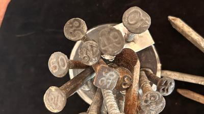 ANTIQUE RAILROAD DATE NAILS AND A GLASS MARBLE REFLECTOR