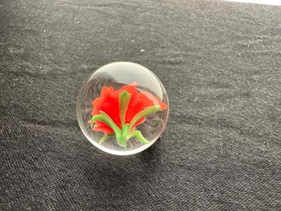 HANDBLOWN RED/ORANGE FLOWER ENCASED IN CLEAR GLASS MARBLE