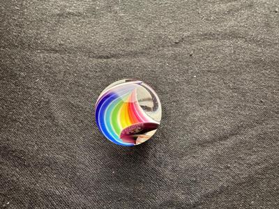 A VIBRANT MULTICOLORED MARBLE WITH A SWIRLING RAINBOW DESIGN