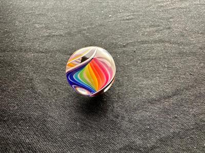 A VIBRANT MULTICOLORED MARBLE WITH A SWIRLING RAINBOW DESIGN