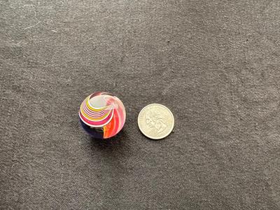 A VIBRANT MULTICOLORED MARBLE WITH A SWIRLING RAINBOW DESIGN