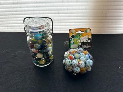 A JAR AND UNOPENED BAG OF MARBLES