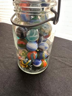 A JAR AND UNOPENED BAG OF MARBLES
