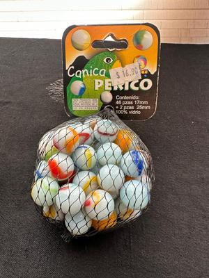 A JAR AND UNOPENED BAG OF MARBLES