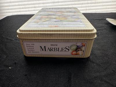 UNOPENED JUNGLE BAG AND A TIN OF MISC MARBLES