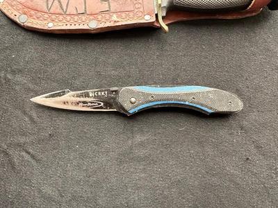 A VARIETY OF KNIVES AND A SHARPENING STONE