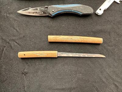 A VARIETY OF KNIVES AND A SHARPENING STONE