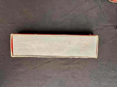 A VARIETY OF KNIVES AND A SHARPENING STONE